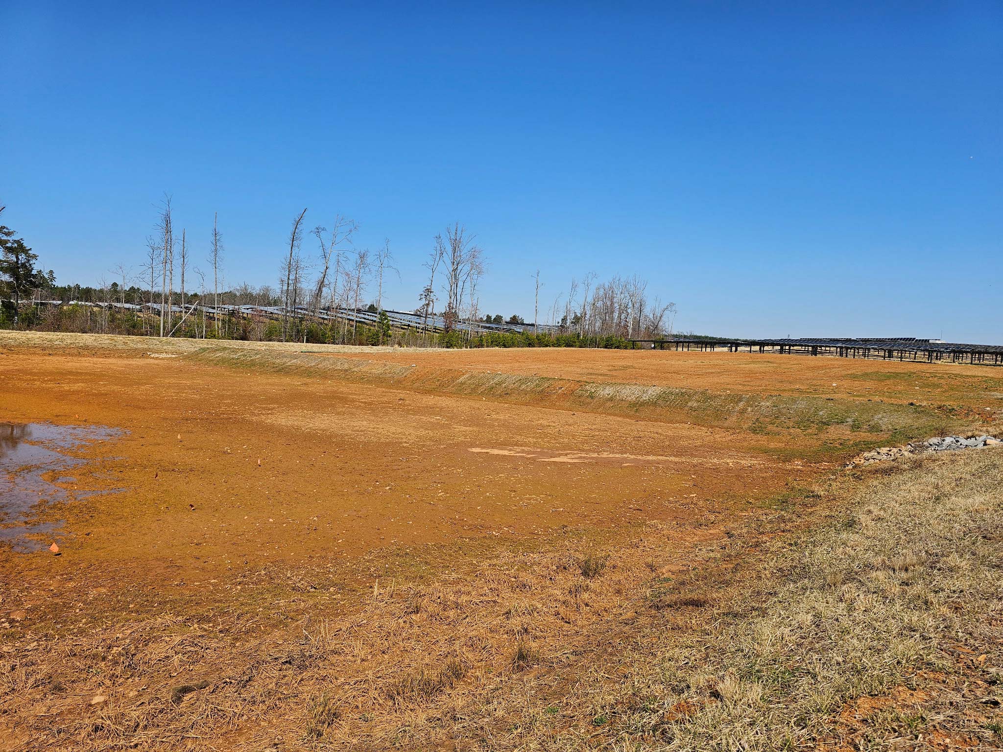 Site before erosion control and grading — bare disturbed soil