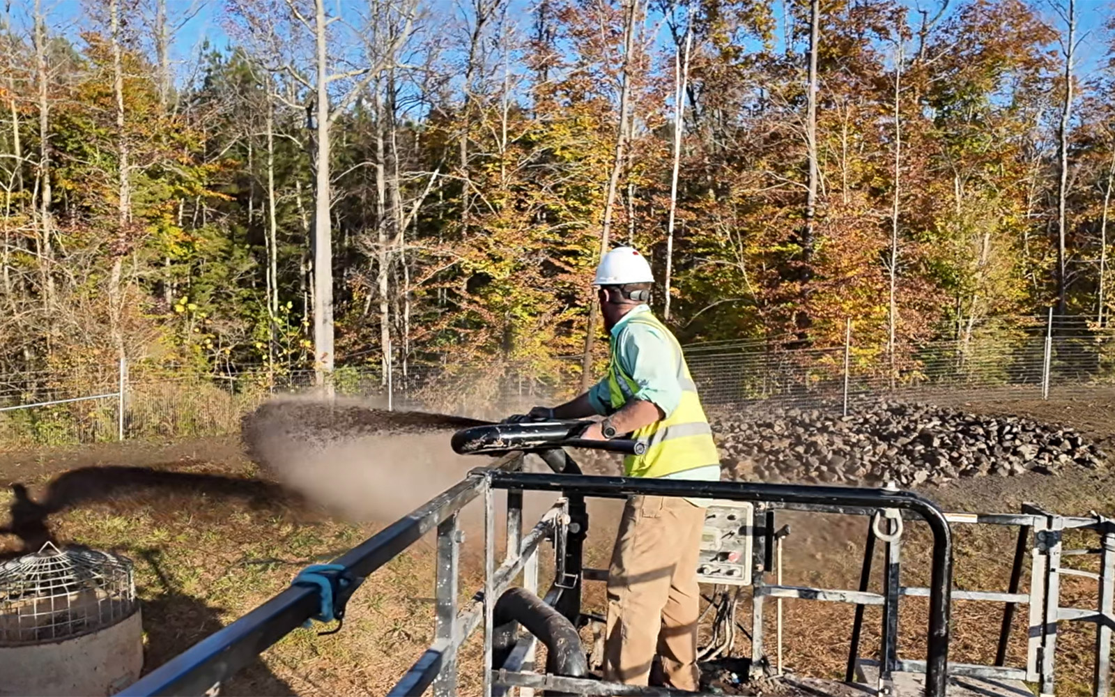 Crew installing erosion control matting on a graded slope